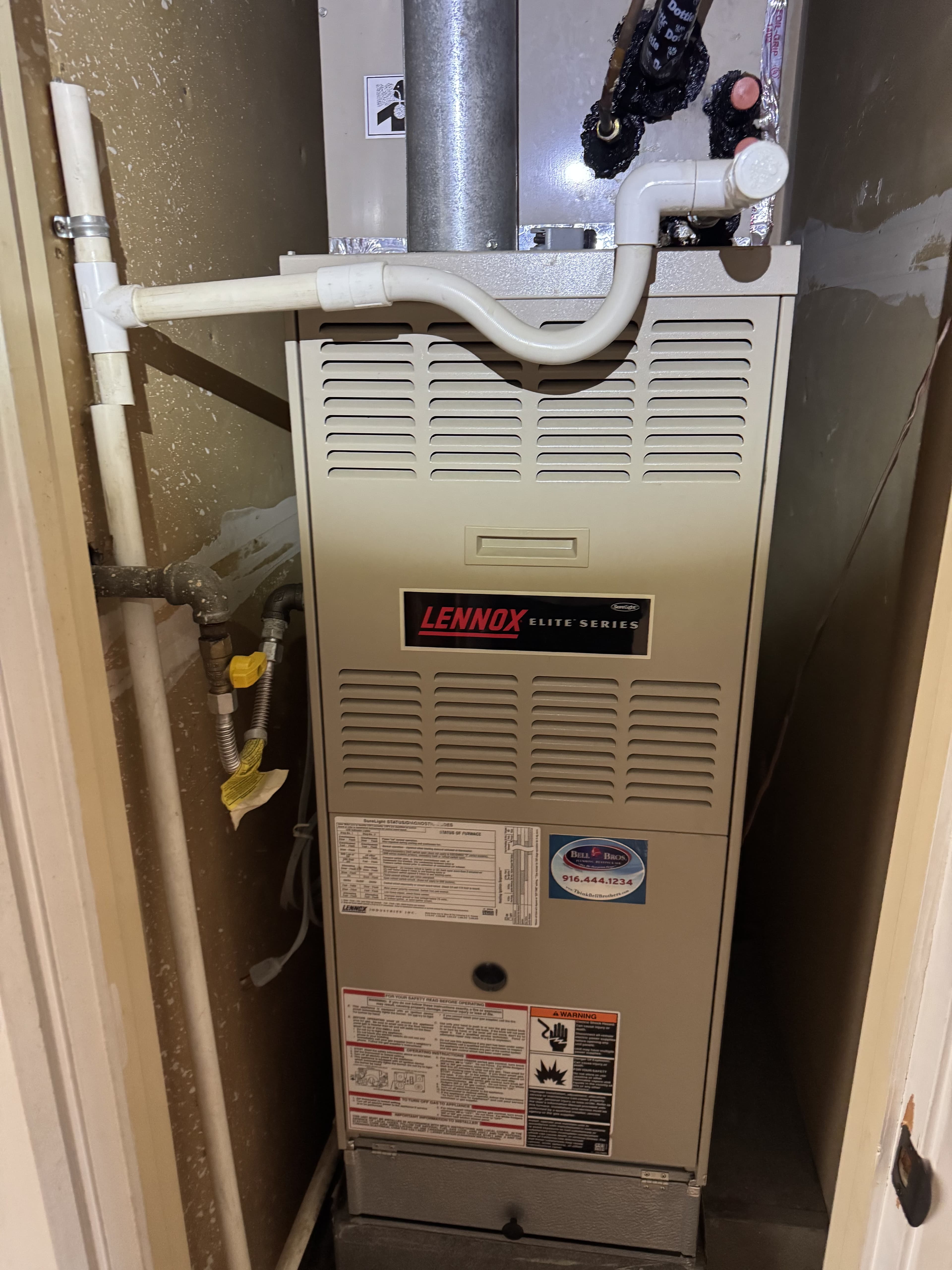 Lennox Elite high-efficiency furnace installed in a utility closet